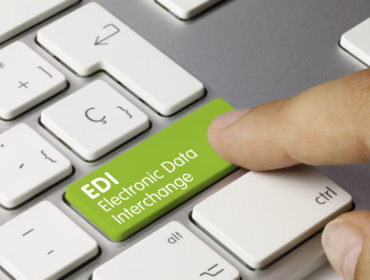 EDI Electronic Data Interchange Written on Green Key of Metallic Keyboard. Finger pressing key.